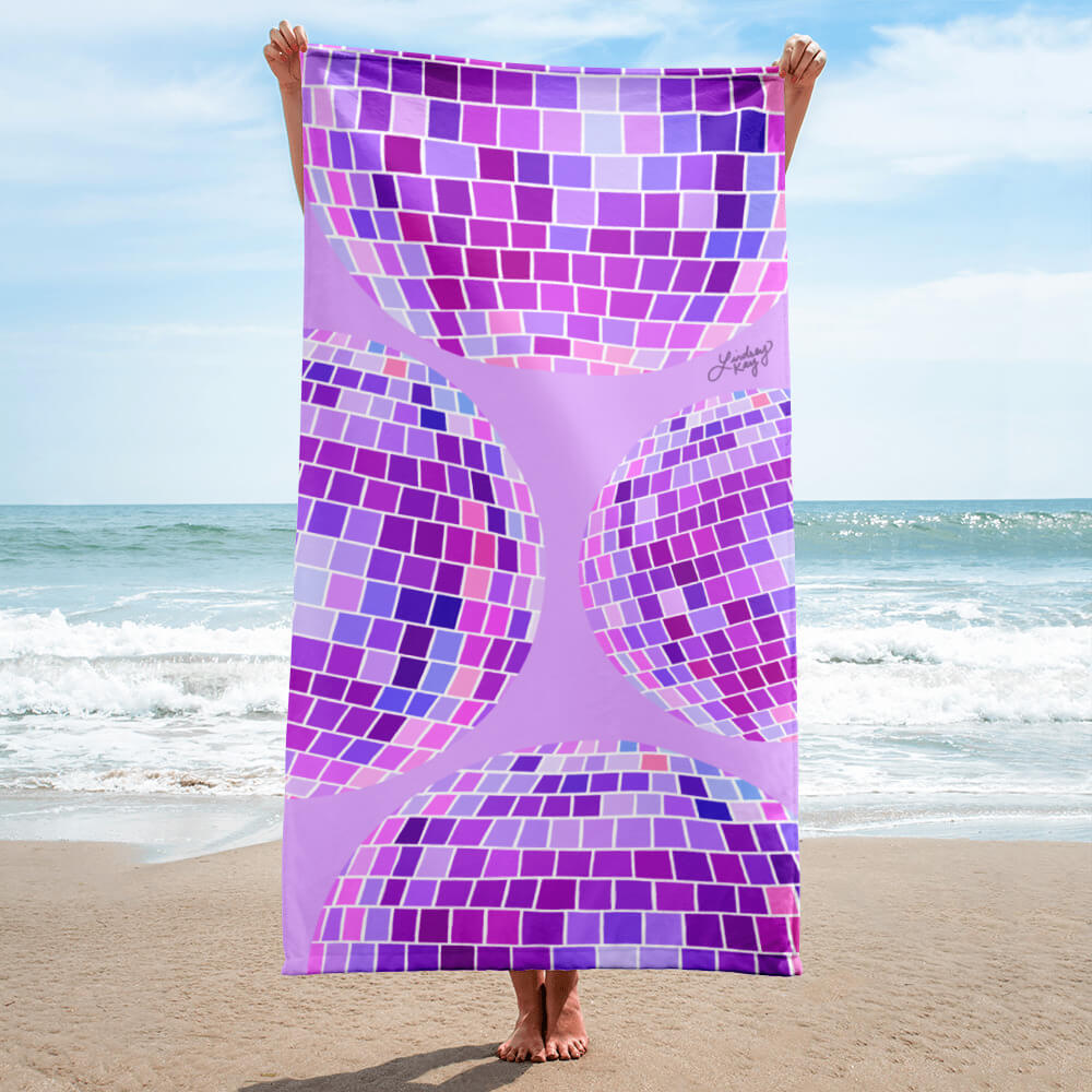 Retro purple disco ball beach towel with hand-illustrated design by Lindsey Kay Collective. Trendy summer towel for beach days, poolside lounging, bachelorette gifts, and retro aesthetic decor. 30x60 cotton polyester towel with vintage disco party vibes.