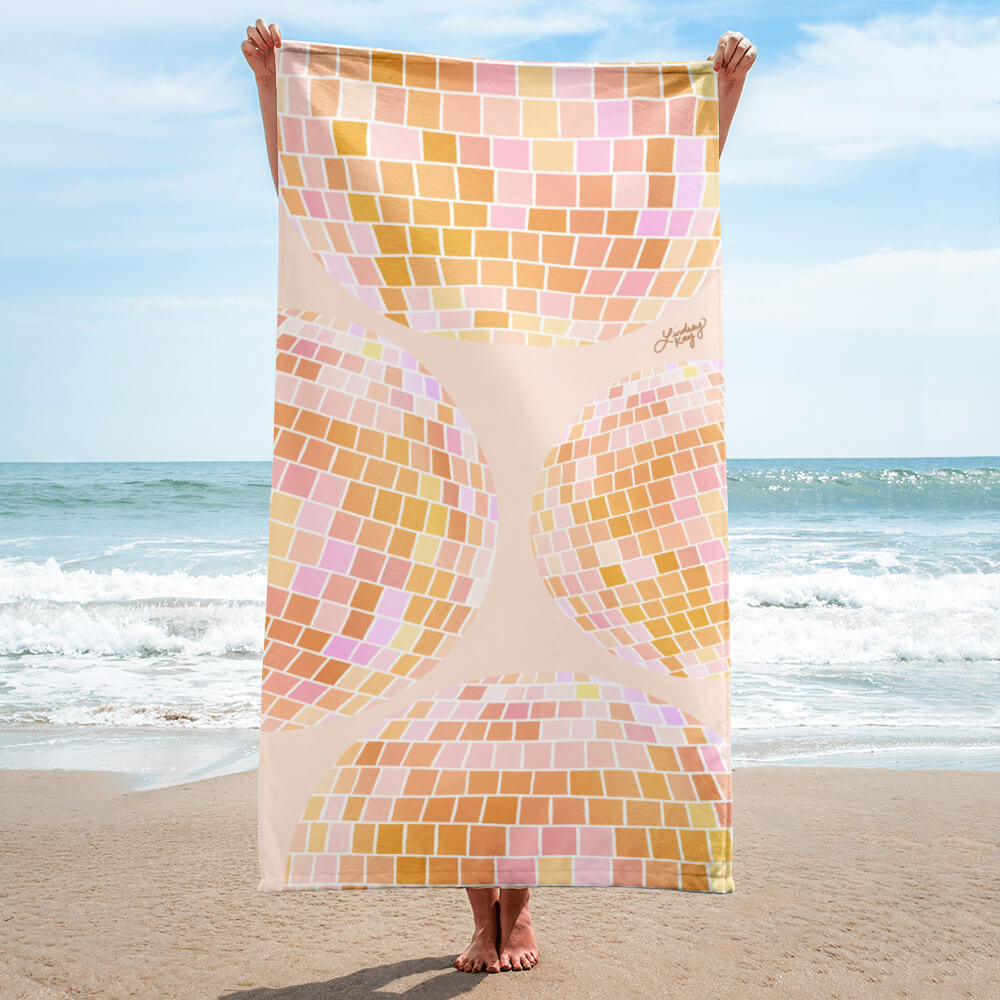 Retro yellow disco ball beach towel with hand-drawn design by Lindsey Kay Collective. Bright summer towel for beach lovers, bachelorettes, retro-inspired poolside decor, and golden aesthetic vibes. 30x60 cotton polyester towel.

