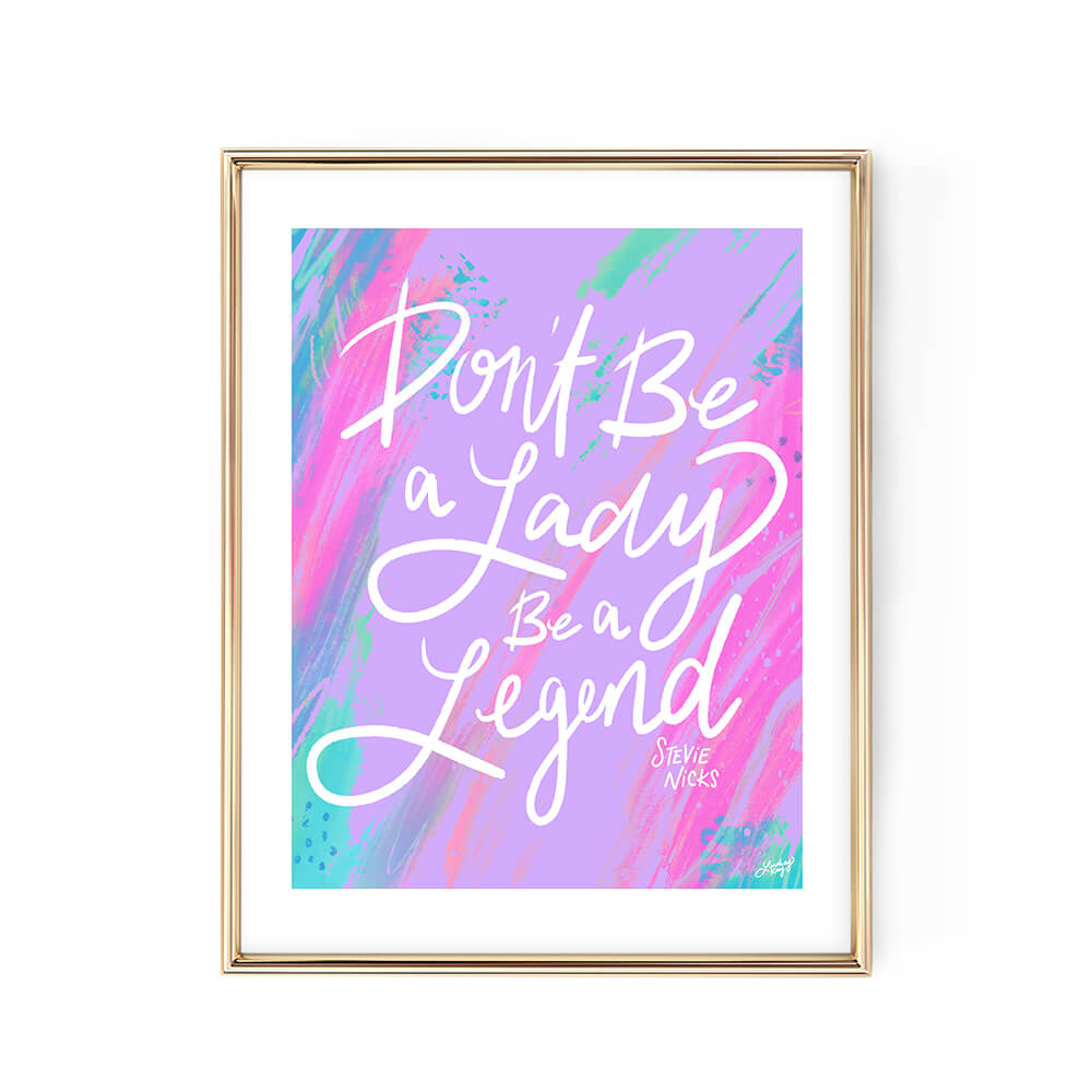 Hand-lettered Stevie Nicks quote art print Don’t Be a Lady Be a Legend by Lindsey Kay Collective – empowering inspirational wall art – available in gold/white, pink, pastel purple/green, and black/purple color palettes – perfect for female empowerment gifts, office decor, dorm rooms, or gallery walls – printed on enhanced matte paper with vibrant inks – available in 10 sizes