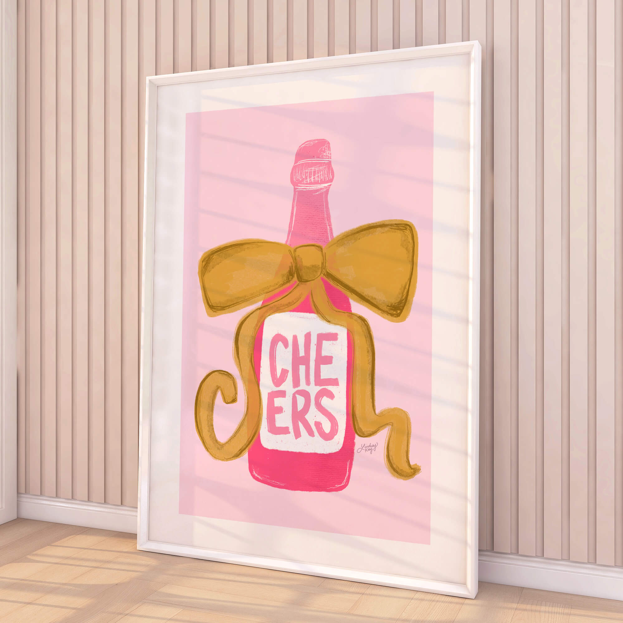 Hand drawn pink champagne bottle art print with gold ribbon that says 'Cheers.' Designed by Lindsey Kay Collective. Perfect for bar cart décor, kitchen walls, or celebratory gallery spaces. Printed on enhanced matte paper, available in multiple sizes.