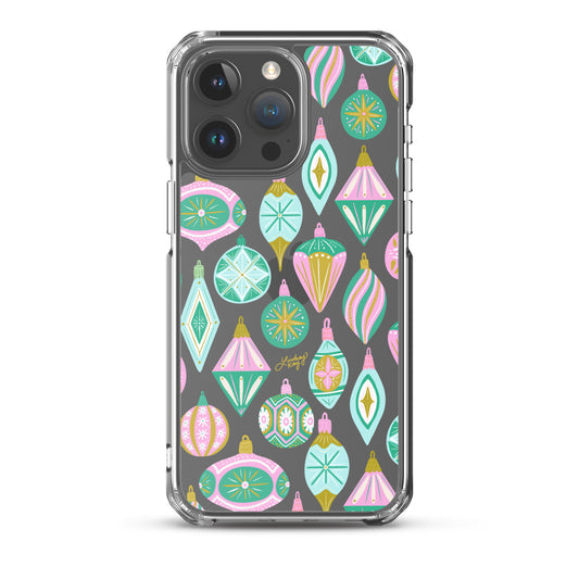 Hand-drawn retro Christmas ornament iPhone case in pastel green, pink, blue, and gold. Festive holiday phone case available in Clear, Tough, MagSafe Clear, and MagSafe Tough for iPhone 11 through iPhone 17. Durable, protective, and illustrated by Lindsey Kay Collective — female-owned small business, no AI used.