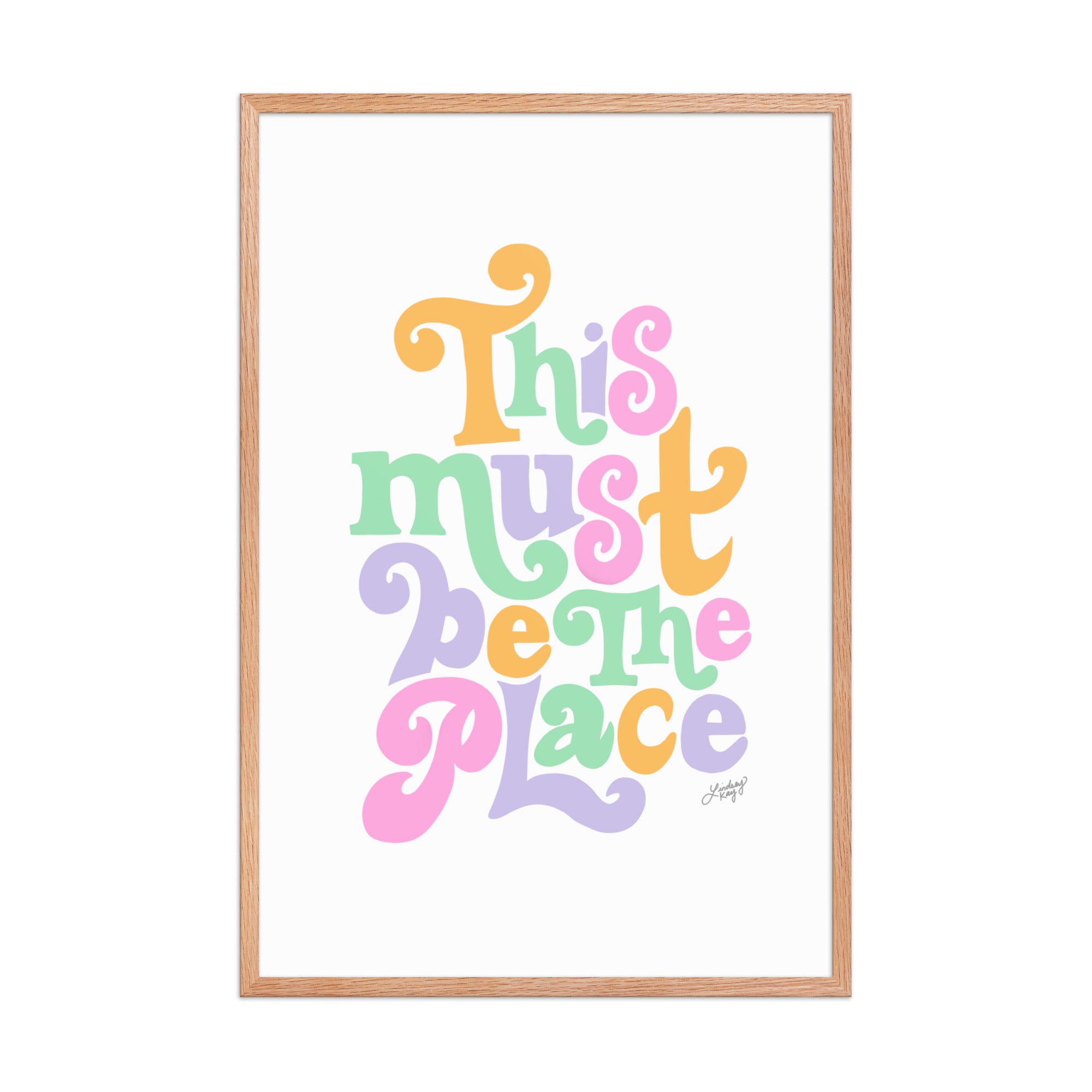 Framed matte art print with hand-lettered quote “This Must Be The Place” in vibrant colors, Lindsey Kay Collective wall art, gallery wall decor