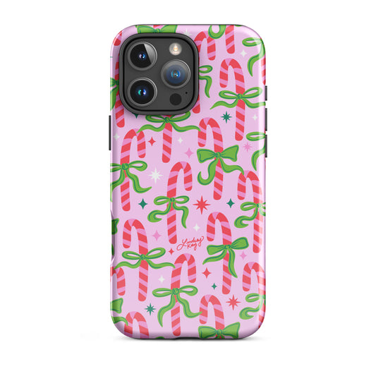 Hand-drawn festive candy cane iPhone case with ribbons in bright greens, pinks, and reds. Holiday phone case for girly, festive style. Available in Clear, Tough, MagSafe Clear, and MagSafe Tough for iPhone 11–17. Hand-illustrated by Lindsey Kay Collective — female-owned small business, no AI used.”