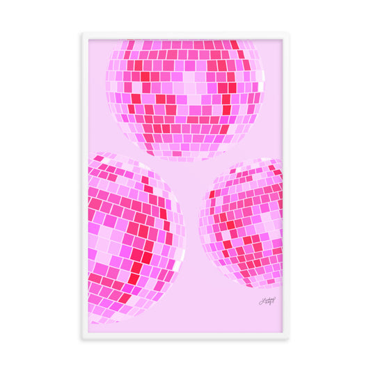 Framed hand-illustrated retro disco ball art print in vibrant pink colors on matte paper, available in white, black, or brown wood frame, 70s-inspired wall decor.